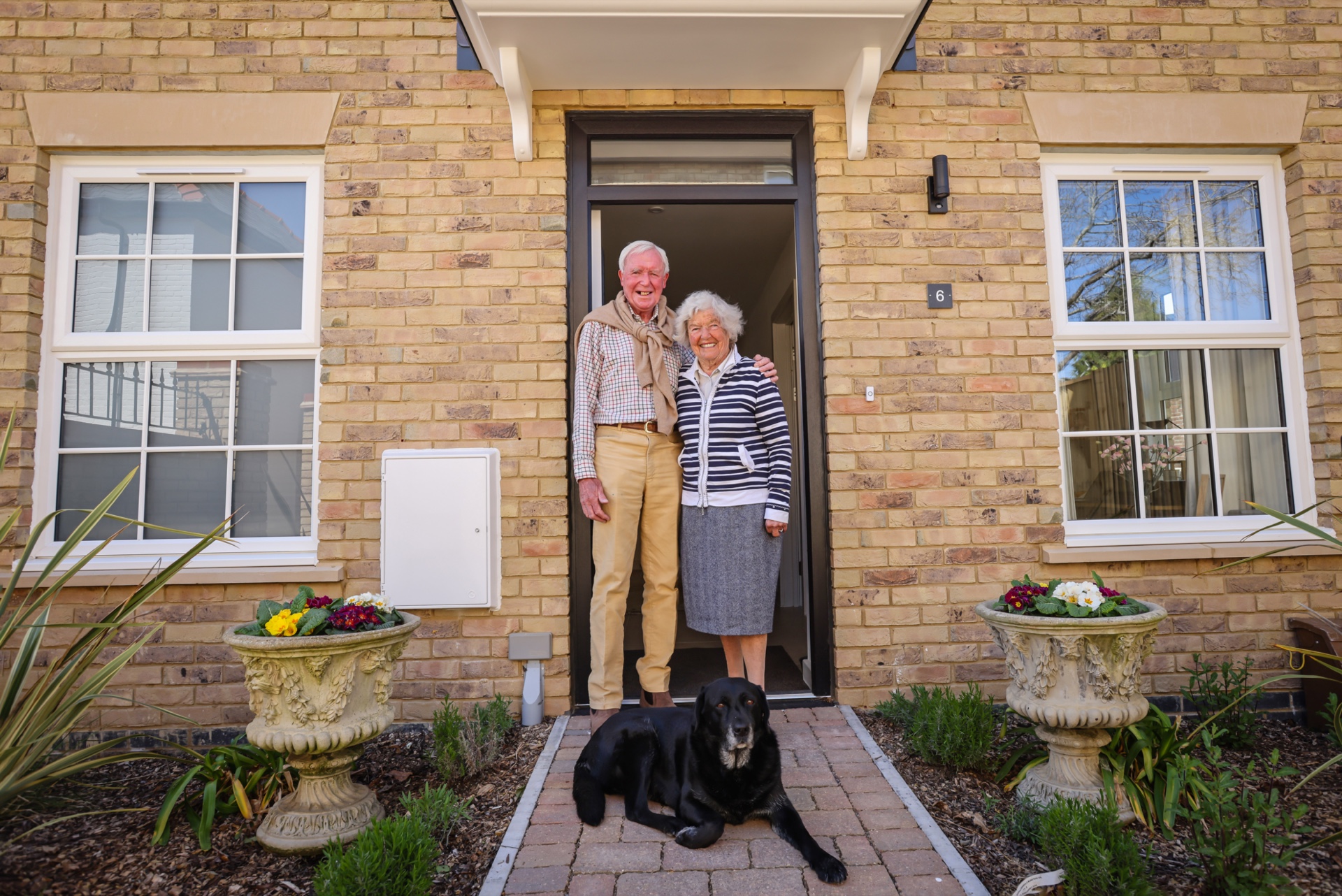 peter and maureen outside their new house
