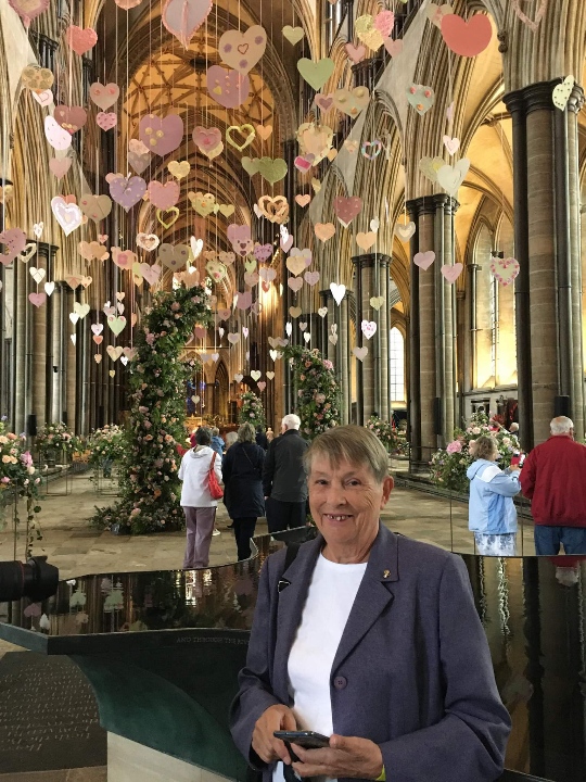 Pearl pictured in Salisbury Cathedral with some of the paper hearts made by Platinum Skies homeowners