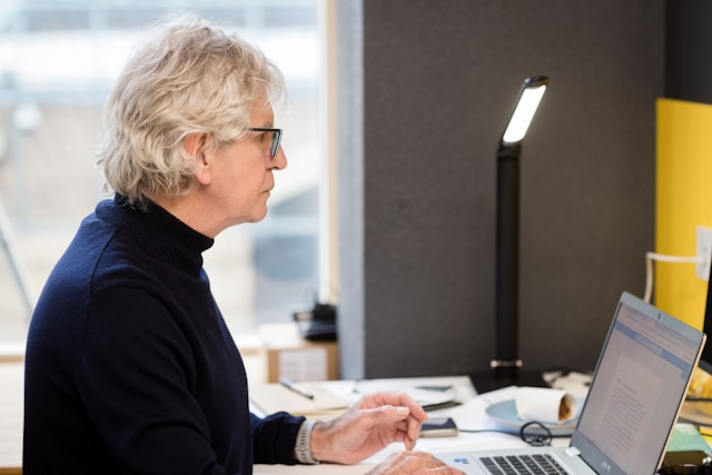 senior women typing on laptop