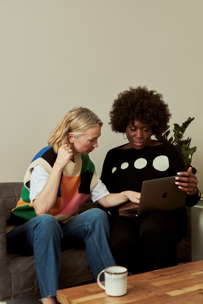 two senior women looking at a laptop